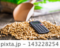 Wood Pellets And Calculator On Table Representing Biofuel Heating Costs And Renewable Energy Budgeting 143228254