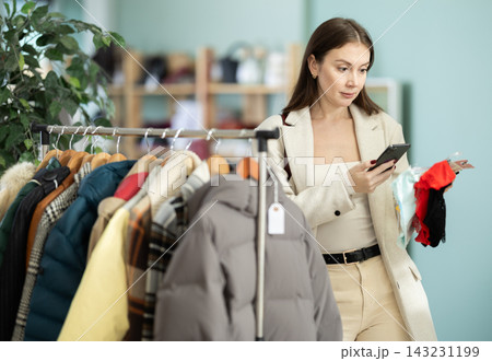 Young woman scans qr code of panties in store Young woman scans qr code of panties in store 143231199