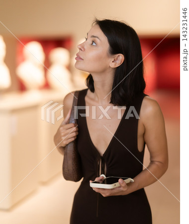Brunette visits the halls of the museum with interest Brunette visits the halls of the museum with interest 143231446