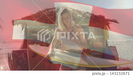 Waxing longboard, woman in tank top and shorts at beach surf shack with red cross overlay. Board, coastal, seashore, shopfront, sunlit, outdoors, rustic 143232671