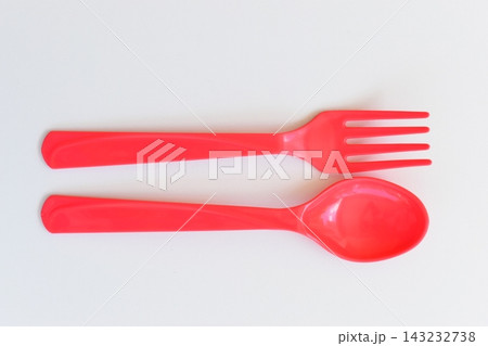 red spoon and fork isolated on white background, plastic cutlery for picnic red spoon and fork isolated on white background, plastic cutlery for picnic 143232738