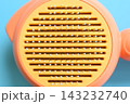 pastel orange comb on blue background, hair brush for pet 143232740