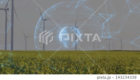 Projecting blue holographic globe hovering above yellow canola field at wind farm, network mesh Projecting blue holographic globe hovering above yellow canola field at wind farm, network mesh 143234339