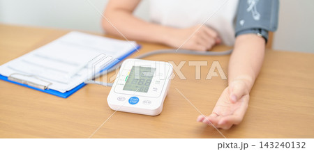 woman checking Blood pressure by Blood pressure monitor with Cuff. Systolic, SYS, Diastolic, DIA, Pulse, Hypertension, Hypotension, Heart rate, Cardiovascular Disease and May World hypertension day woman checking Blood pressure by Blood pressure monitor with Cuff. Systolic, SYS, Diastolic, DIA, Pulse, Hypertension, Hypotension, Heart rate, Cardiovascular Disease and May World hypertension day 143240132