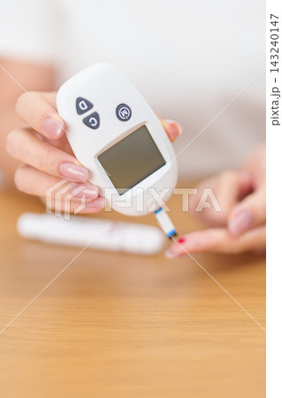 Hand checking Diabetes or Blood glucose self testing by digital blood glucose meter with lancet pen. high blood sugar level, World Diabetes Day, Glycemia, Hypoglycemia, Hyperglycemia and insulin Hand checking Diabetes or Blood glucose self testing by digital blood glucose meter with lancet pen. high blood sugar level, World Diabetes Day, Glycemia, Hypoglycemia, Hyperglycemia and insulin 143240147