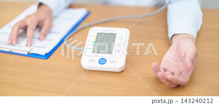 Man checking Blood pressure by Blood pressure monitor with Cuff. Systolic, SYS, Diastolic, DIA, Pulse, Hypertension, Hypotension, Heart rate, Cardiovascular Disease and May World hypertension day 143240212
