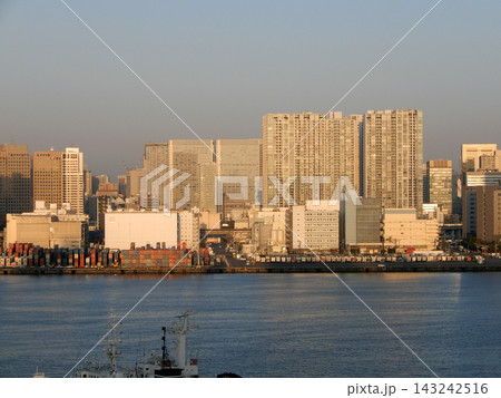 早朝のオレンジ色の光を浴びる東京湾岸のビル群 143242516