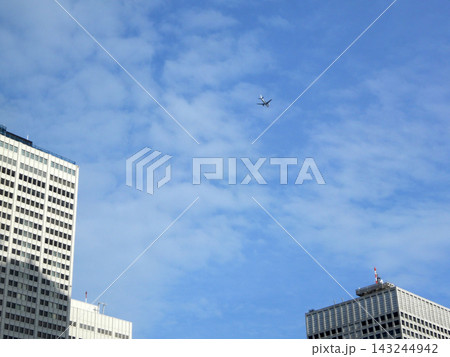 新宿西口の高層ビル上空を通過して羽田空港に向かう飛行機 新宿西口の高層ビル上空を通過して羽田空港に向かう飛行機 143244942