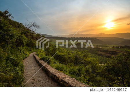 Stone footpath along a green hillside at sunset near Ronda, Spain Stone footpath along a green hillside at sunset near Ronda, Spain 143246637