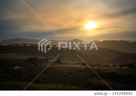 Golden sunset over rolling hills and farmland in the Ronda countryside, Spain 143246642