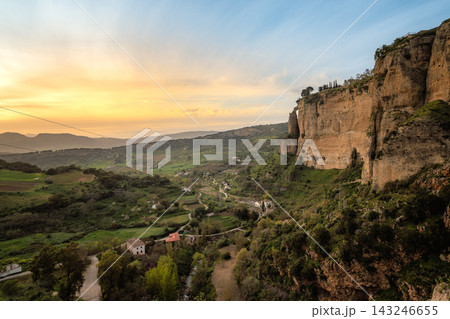 Sunset over Ronda cliffs and the green Andalusian valley below Sunset over Ronda cliffs and the green Andalusian valley below 143246655