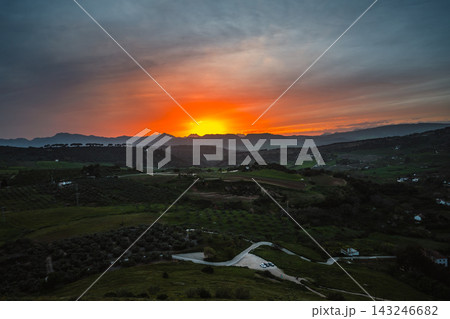 Vibrant sunset over rolling farmland and mountains outside Ronda Vibrant sunset over rolling farmland and mountains outside Ronda 143246682