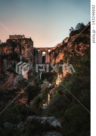 Puente Nuevo bridge spanning El Tajo gorge with waterfall in Ronda at dusk Puente Nuevo bridge spanning El Tajo gorge with waterfall in Ronda at dusk 143246692