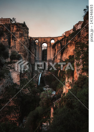 Puente Nuevo bridge spanning El Tajo gorge with waterfall in Ronda at dusk Puente Nuevo bridge spanning El Tajo gorge with waterfall in Ronda at dusk 143246693