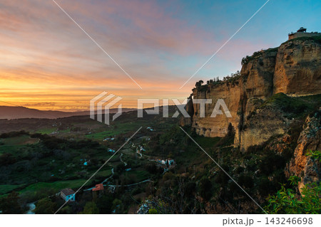 Golden sunset over Ronda valley beside towering limestone cliffs Golden sunset over Ronda valley beside towering limestone cliffs 143246698