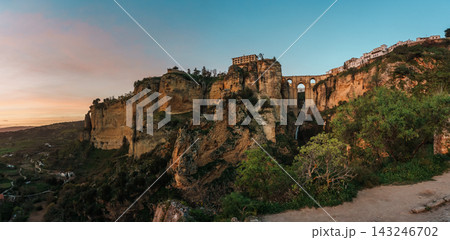 Puente Nuevo bridge spanning El Tajo gorge with waterfall in Ronda at dusk 143246702