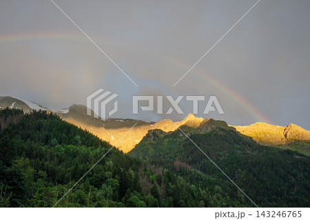Rainbow over mountain forest at Contamines Montjoie, France Rainbow over mountain forest at Contamines Montjoie, France 143246765