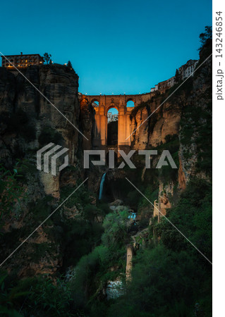 Illuminated Puente Nuevo bridge over El Tajo gorge in Ronda at blue hour Illuminated Puente Nuevo bridge over El Tajo gorge in Ronda at blue hour 143246854