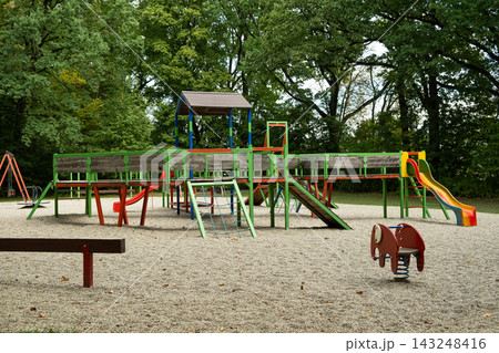 Children playground with colorful slides and climbing structures in park 143248416