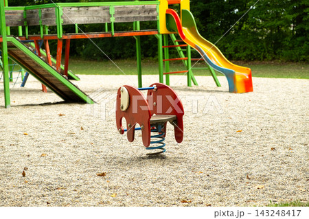 Red elephant spring rider toy on children playground 143248417