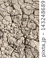 Dry Cracked Earth Soil Surface.Close-up view of arid, cracked earth suffering from severe drought and extreme climate conditions. Dry Cracked Earth Soil Surface.Close-up view of arid, cracked earth suffering from severe drought and extreme climate conditions. 143248689