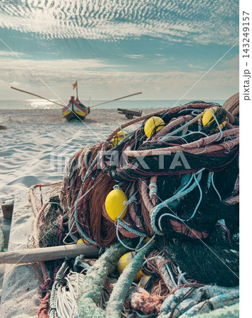 Fishing net and traditional boat on Portugal beach Fishing net and traditional boat on Portugal beach 143249157