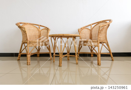 Rattan chairs and a round coffee table in a modern living room 143250961
