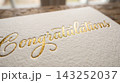Extreme close up detail focusing on the luxurious texture of a gift card resting on a book cover 143252037