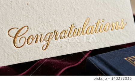 Extreme close up detail focusing on the luxurious texture of a gift card resting on a book cover 143252039