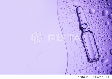 Ampoule with medicine or cosmetic product on wet transparent glass Ampoule with medicine or cosmetic product on wet transparent glass 143254251