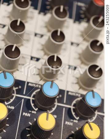 Audio mixing console with colorful control knobs Audio mixing console with colorful control knobs 143255009