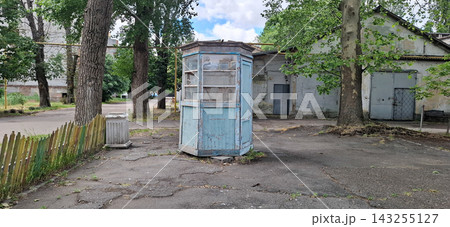 Vintage wooden booth, possibly a former newsstand, in the old, abandoned industrial courtyard of the Odessa Film Studio. Vintage wooden booth, possibly a former newsstand, in the old, abandoned industrial courtyard of the Odessa Film Studio. 143255127