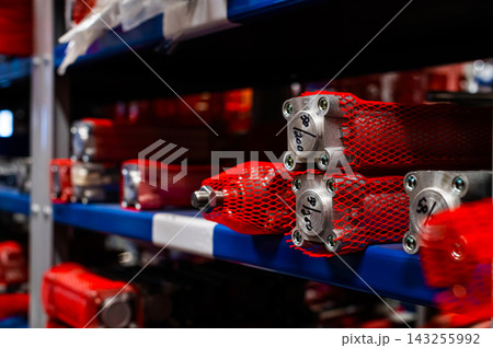 Industrial warehouse shelves with mechanical parts and cylinders 143255992