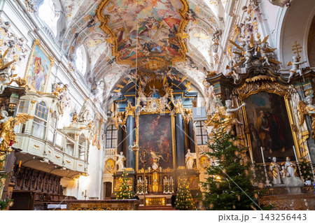 Interior of the baroque Basilica of Saint Emmeram with decorated Christmas trees during winter holiday season in Regensburg, Germany Interior of the baroque Basilica of Saint Emmeram with decorated Christmas trees during winter holiday season in Regensburg, Germany 143256443