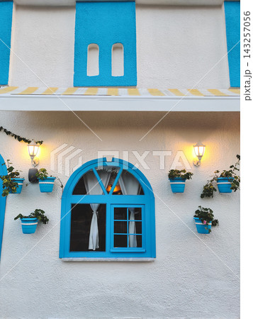 Blue arched window with decorative flower pots in Demre, Turkey 143257056