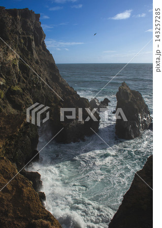 Dramatic volcanic cliffs and sea stack at Reykjanesviti coast in Iceland Dramatic volcanic cliffs and sea stack at Reykjanesviti coast in Iceland 143257285
