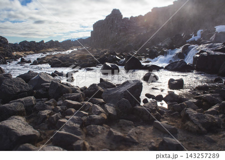 Oxararfoss waterfall in Thingvellir National Park Iceland with water flowing over dark rocks 143257289