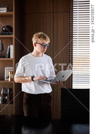 Casual young professional preparing pitch in sunlit office space Casual young professional preparing pitch in sunlit office space 143258877
