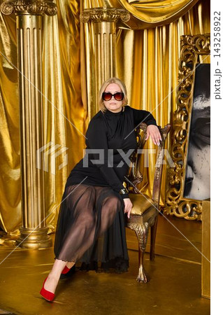 Stylish artistic shoot with opulent studio backdrop and fashionable pose Stylish artistic shoot with opulent studio backdrop and fashionable pose 143258922