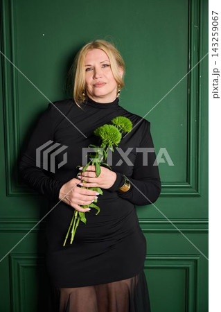 Elegant female showcasing floral display and stylish accessories Elegant female showcasing floral display and stylish accessories 143259067