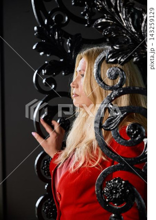 Closeup of stylish woman in red with soft side lighting expression Closeup of stylish woman in red with soft side lighting expression 143259129