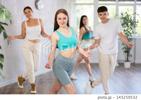 Group of young women and young guy dancing jazz funk Group of young women and young guy dancing jazz funk 143259532