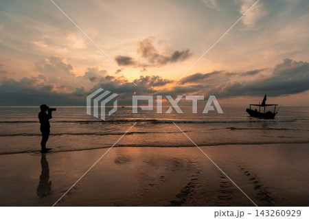 Silhouette Photographer and Traditional Boat at Golden Tropical Sunrise 143260929