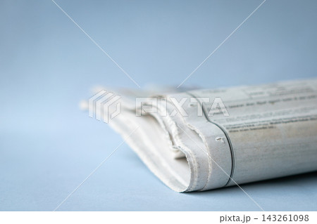 Newspaper folded on top of desk Newspaper folded on top of desk 143261098