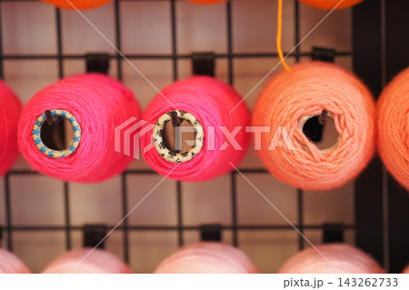 Bright colors of yarn displayed on shelves in a craft store Bright colors of yarn displayed on shelves in a craft store 143262733