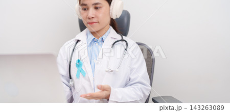 doctor using laptop for telehealth, online consultation and meeting about blue Ribbon concept of November Prostate Cancer Awareness month, Diabetes day , Men Health, International men, Father day. doctor using laptop for telehealth, online consultation and meeting about blue Ribbon concept of November Prostate Cancer Awareness month, Diabetes day , Men Health, International men, Father day. 143263089