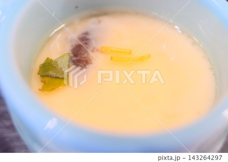 出汁の風味を楽しむ上品な和食の定番、茶碗蒸しを器に盛り付けた一品 出汁の風味を楽しむ上品な和食の定番、茶碗蒸しを器に盛り付けた一品 143264297