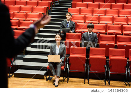 講演会で真剣な表情で発表を聞くビジネスパーソンの男女 講演会で真剣な表情で発表を聞くビジネスパーソンの男女 143264506