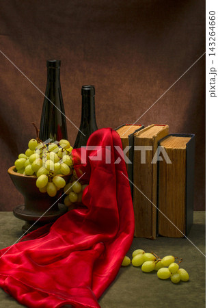 Still Life with grapes, books, bottles, and red fabric 143264660