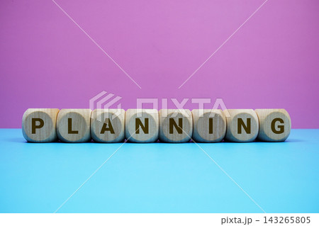 PLANNING alphabet letters wooden cube with alarm clock on pink and blue background PLANNING alphabet letters wooden cube with alarm clock on pink and blue background 143265805